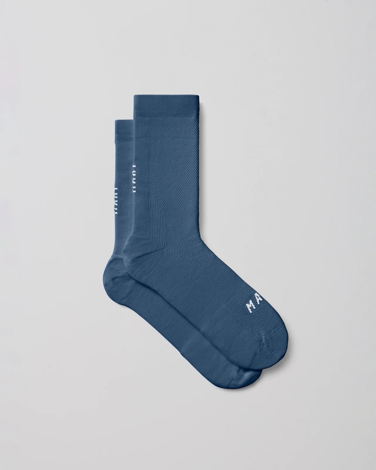 A pair of MAAP Division Mono Socks in Uniform Blue with a white background