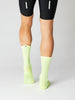 A pair of Fingerscrossed road cycling socks in neon green