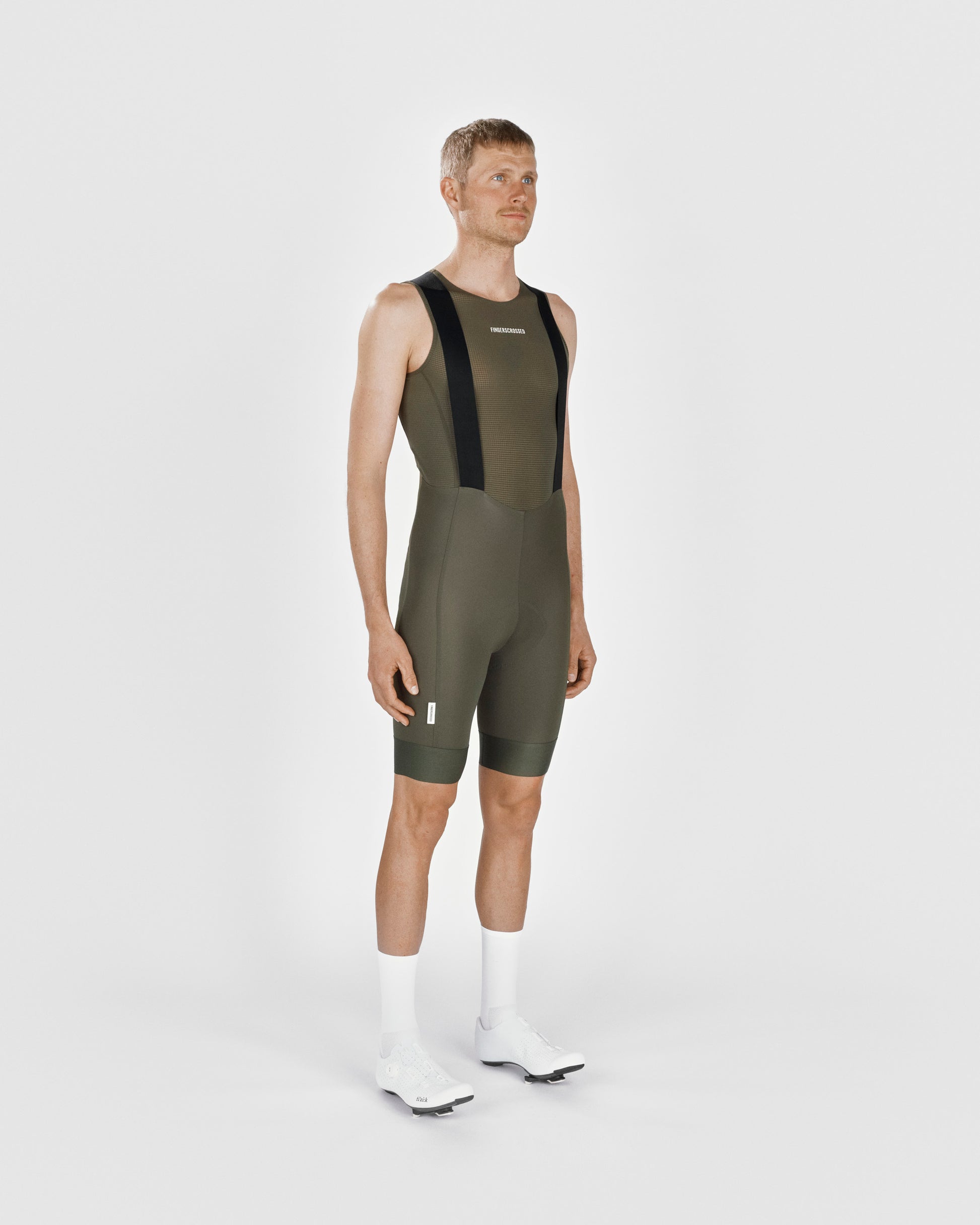 A male cyclist showing the front of a Fingerscrossed #Road cycling Bib Shorts in Olive