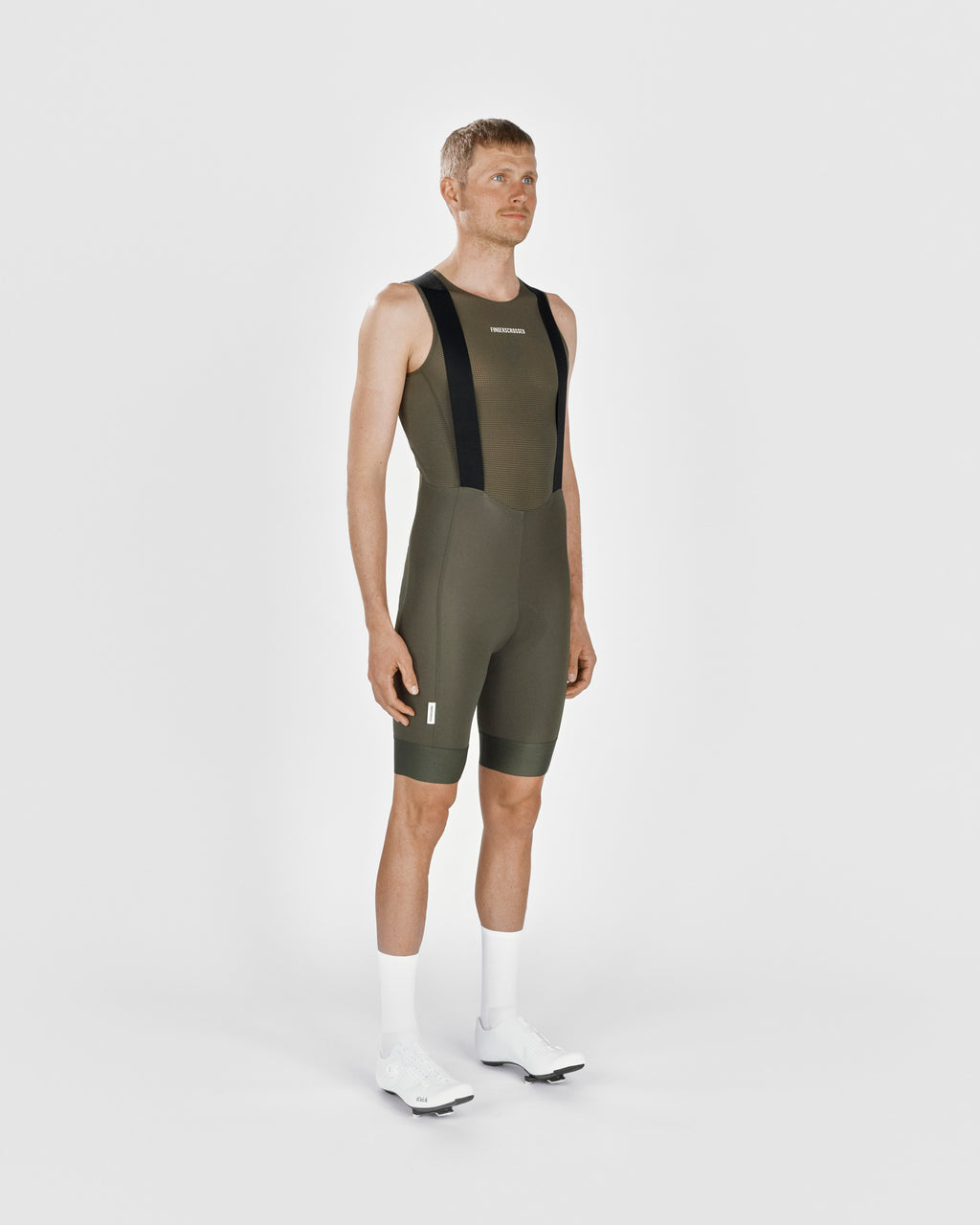 A male cyclist showing the front of a Fingerscrossed #Road cycling Bib Shorts in Olive