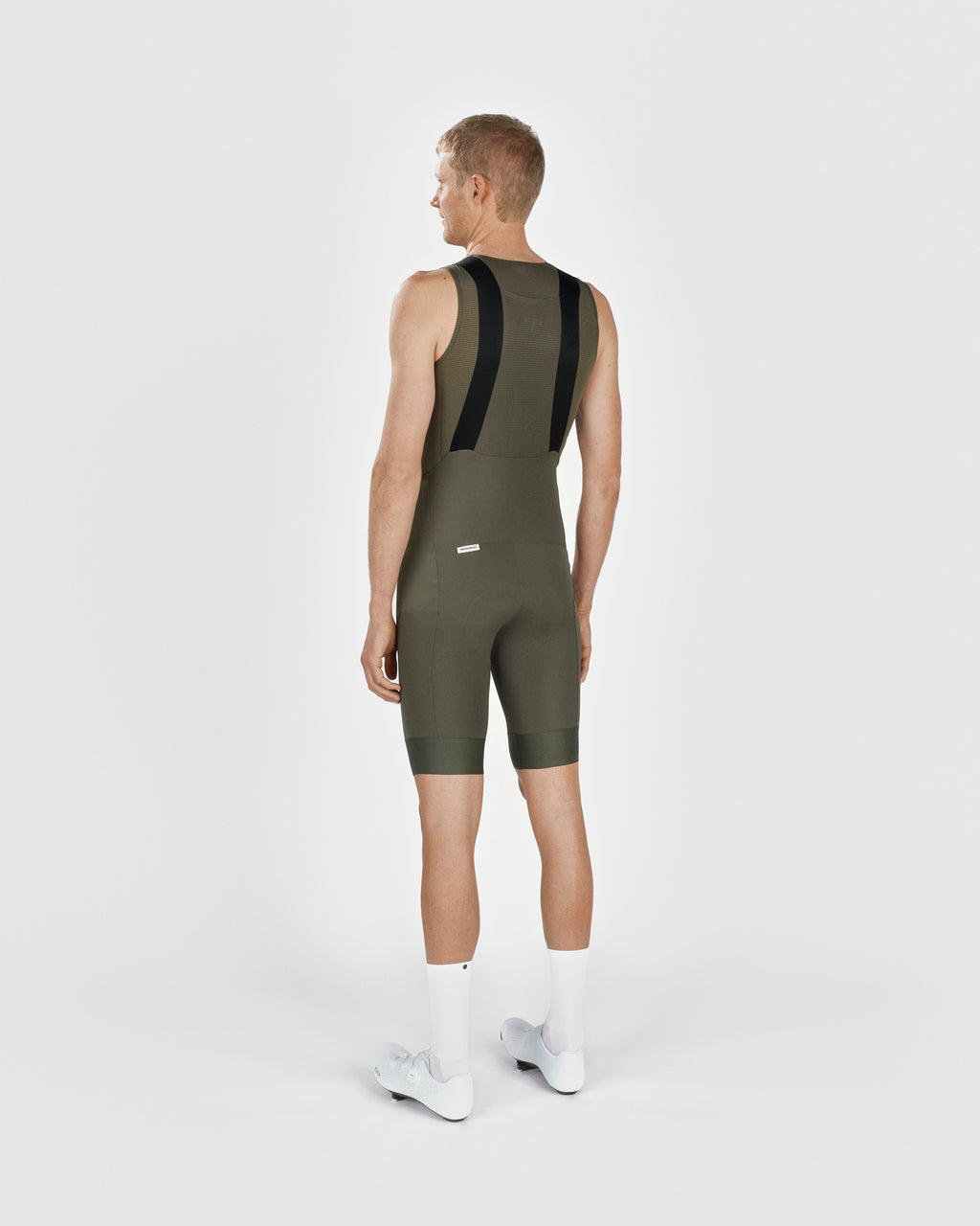 A male cyclist showing the back of a Fingerscrossed #Road cycling Bib Shorts in Olive