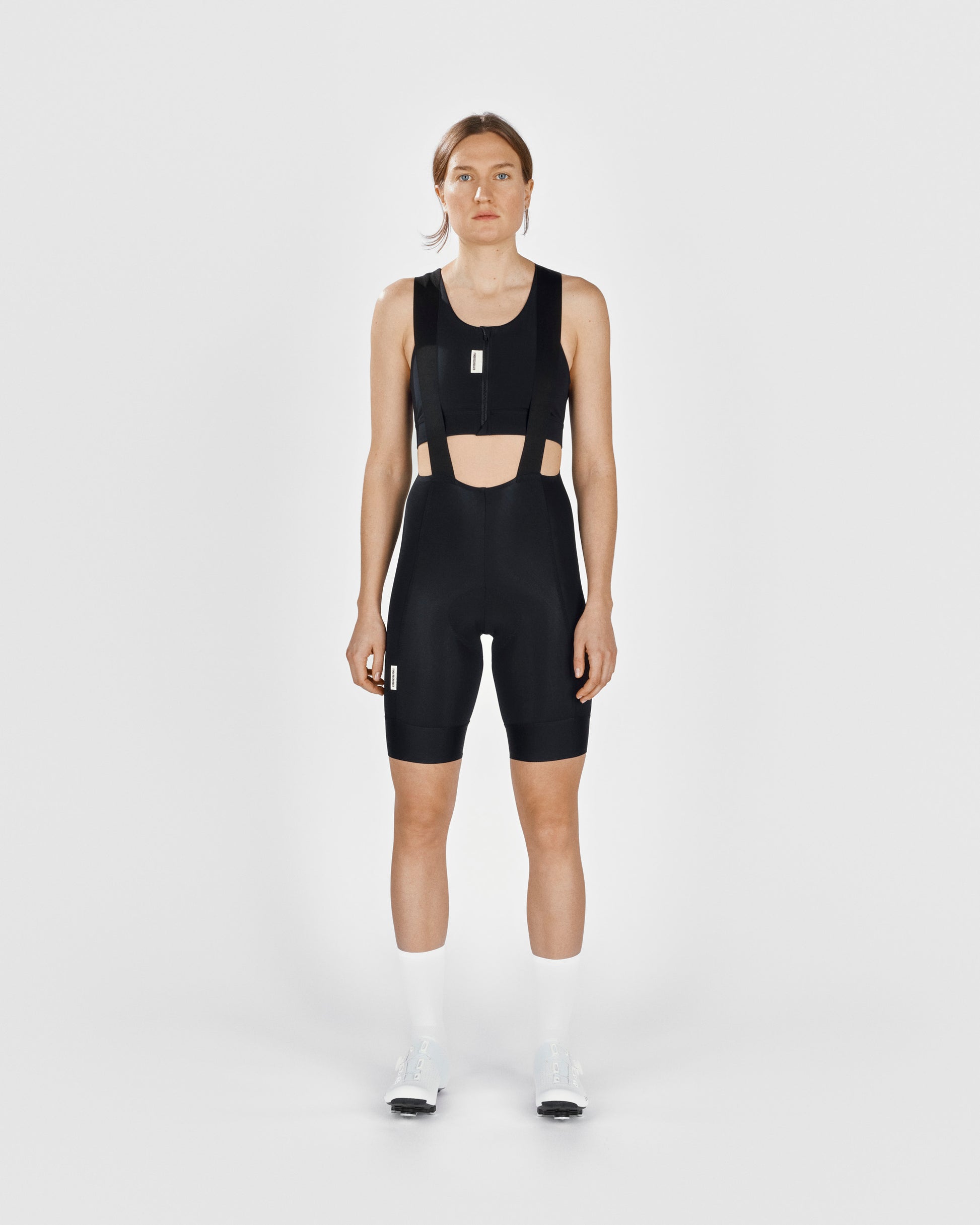 A female cyclist showing the front of a Fingerscrossed #Road cycling women's bra in black