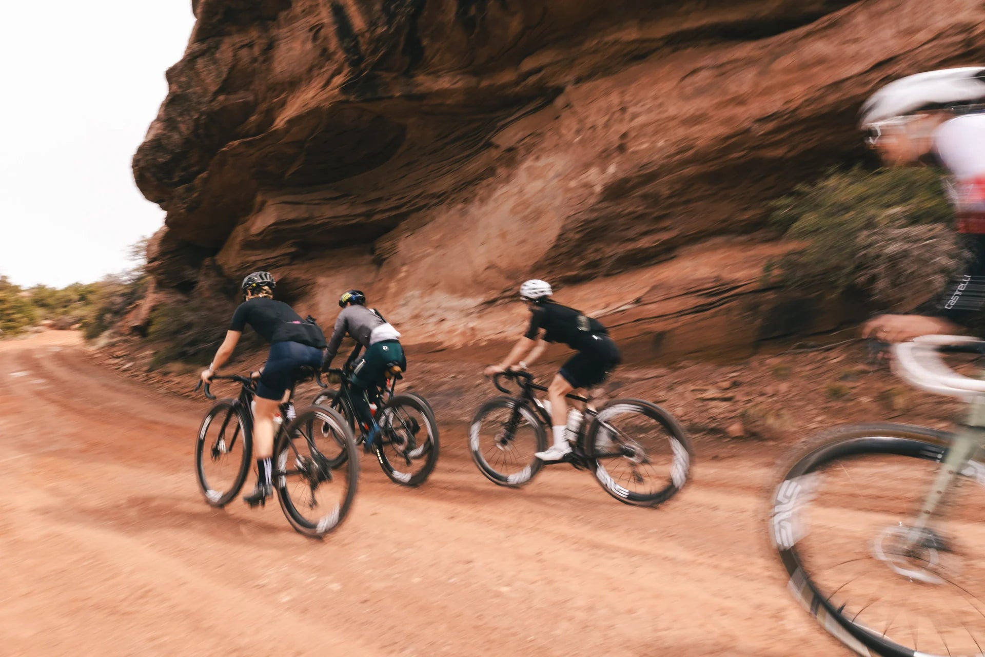A group of cyclists riding down a dirt road on Enve MOGs