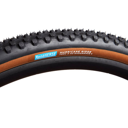 A Rene Herse Hurricane Ridge 700c x 42 gravel bicycle tire with tan side walls and endurance casing