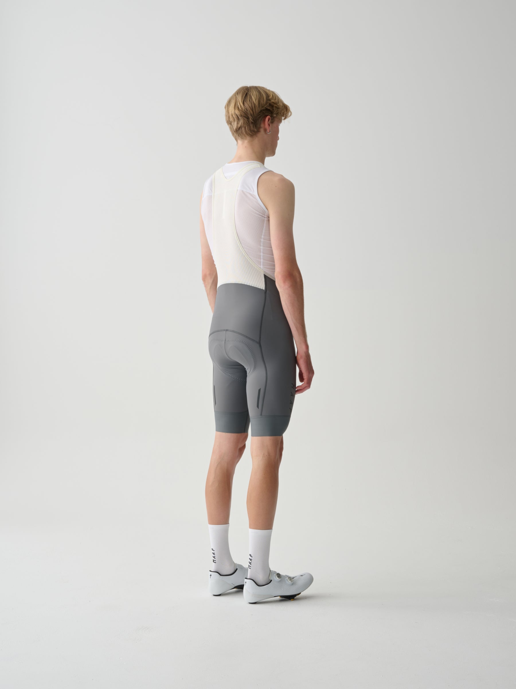 The back of a male model wearing gray MAAP Team Bib Evo cycling bib shorts