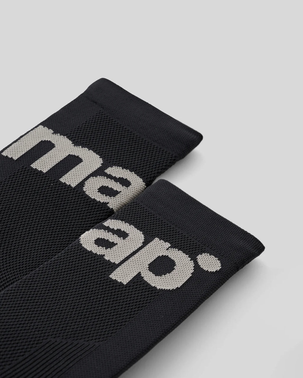 The cuff of MAAP training socks in black with grey logo