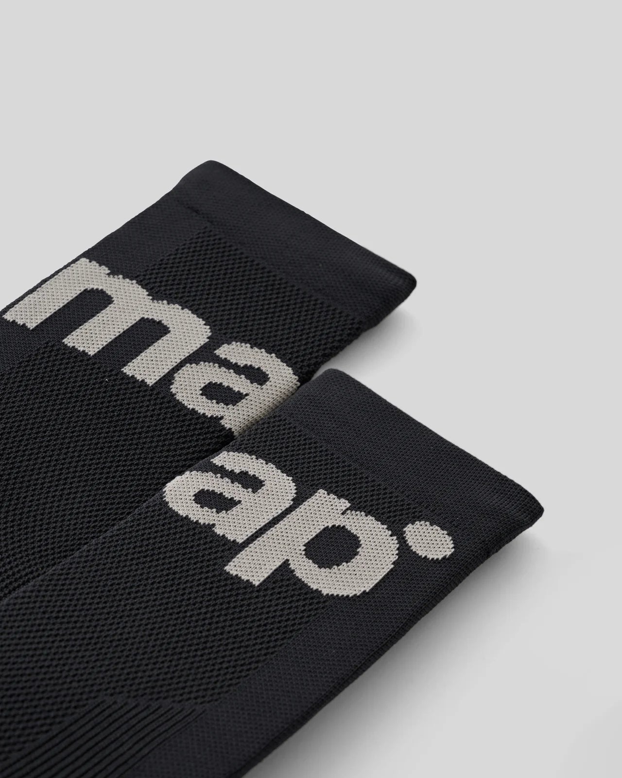 The cuff of MAAP training socks in black with grey logo