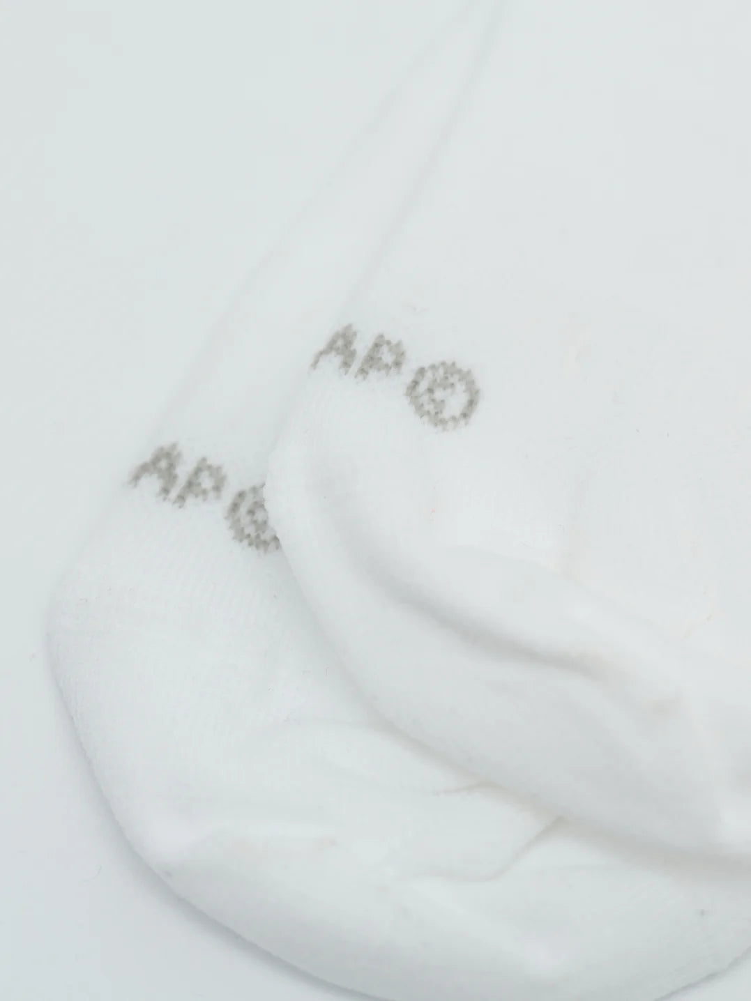 A detail of "MAAP c" branding on the toe of pair of MAAP Team Socks in white