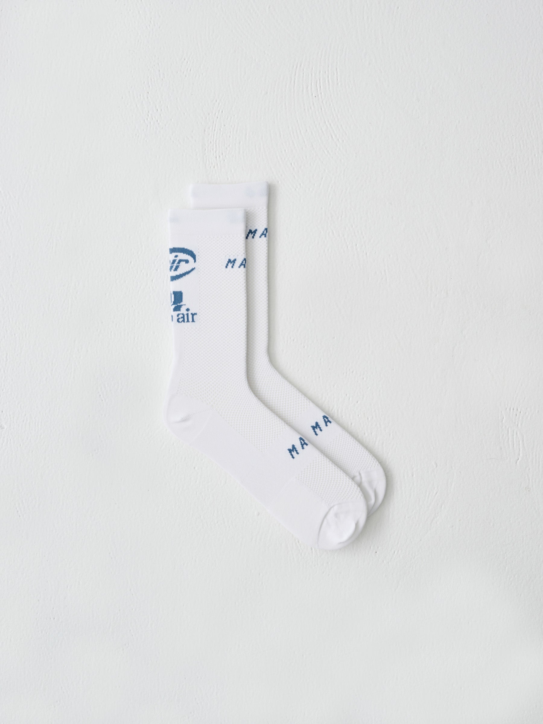 A flat lay image of MAAPs Aether sock in White