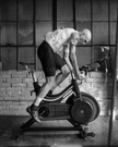 A cyclist riding an indoor trainer during an INSCYD test protocol to establish their metabolic profile at Métier Racing and Coffee