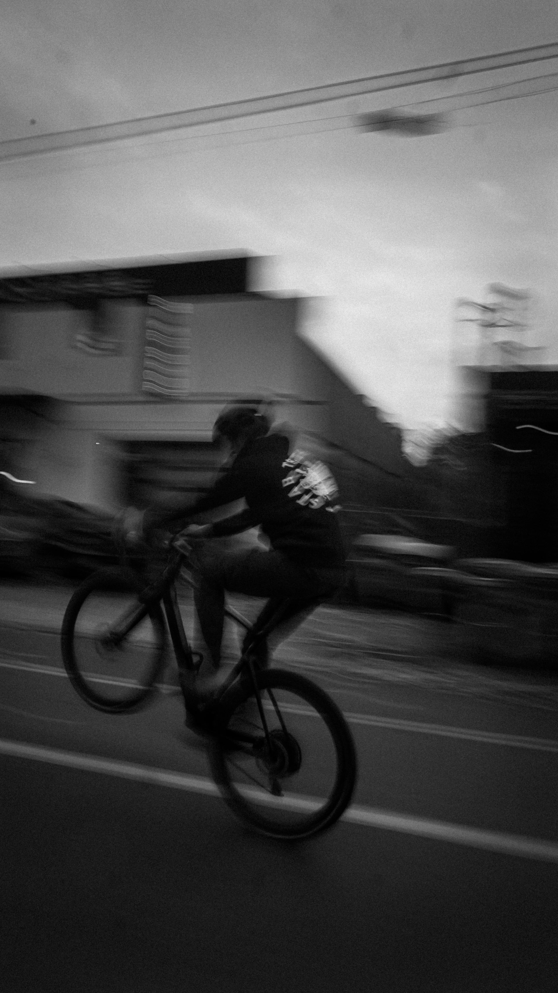 Cyclist doing a wheelie while wearing a Métier Stab The Beast STB Hoodie