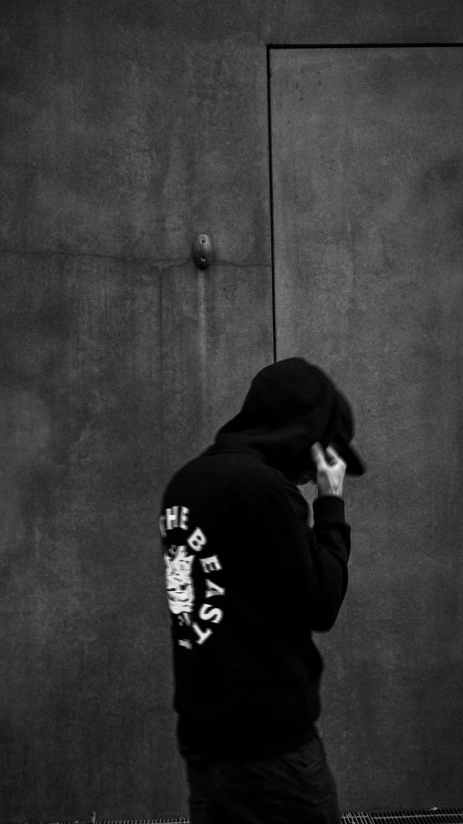 A man wearing a Métier STB Stab The Beast Hoodie, back view