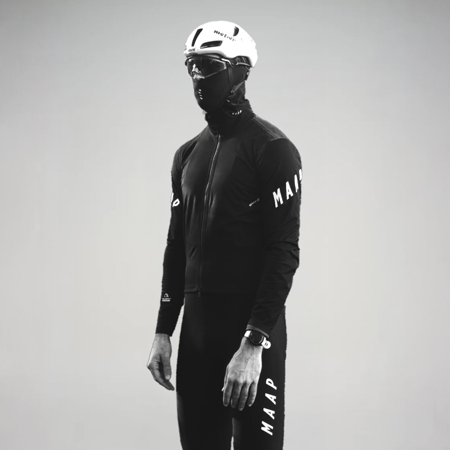 A cyclist wearing MAAP winter cycling kit in front of a white background.
