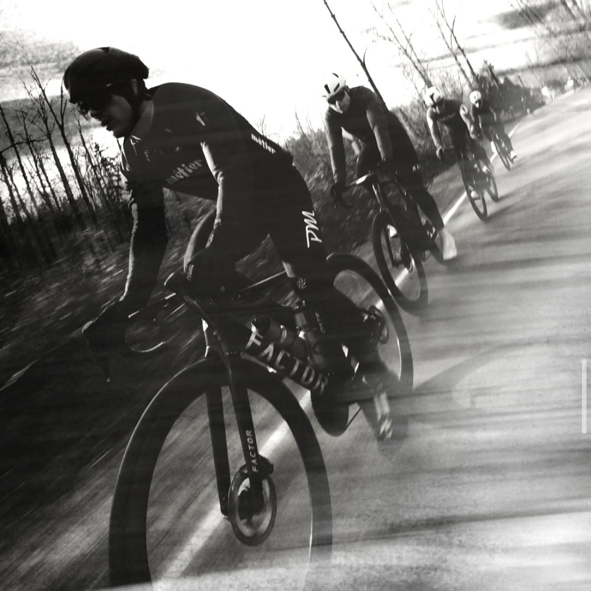 Metier cyclists riding down a road with blurred motion effect