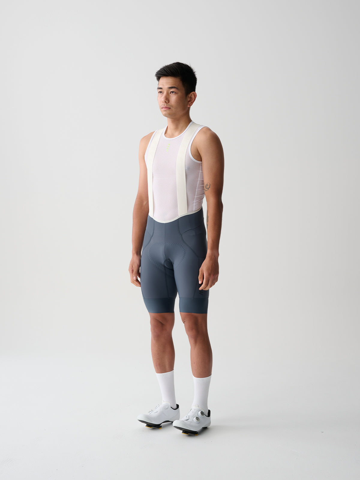 A male model wearing MAAP Team Bib Evo Cycling bib shorts in the Midnight
