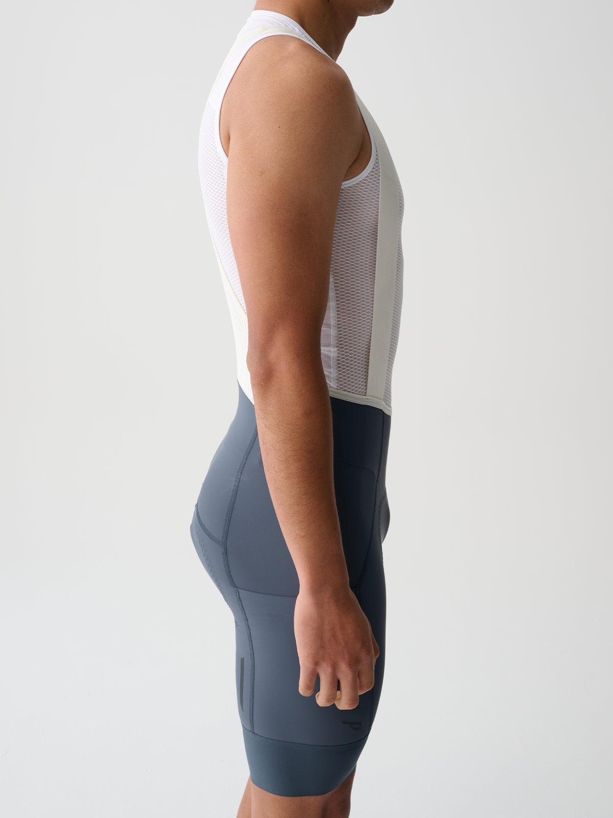 The side of a male model wearing a pair of Midnight MAAP Team Bib Evo Cargo cycling Bib Shorts