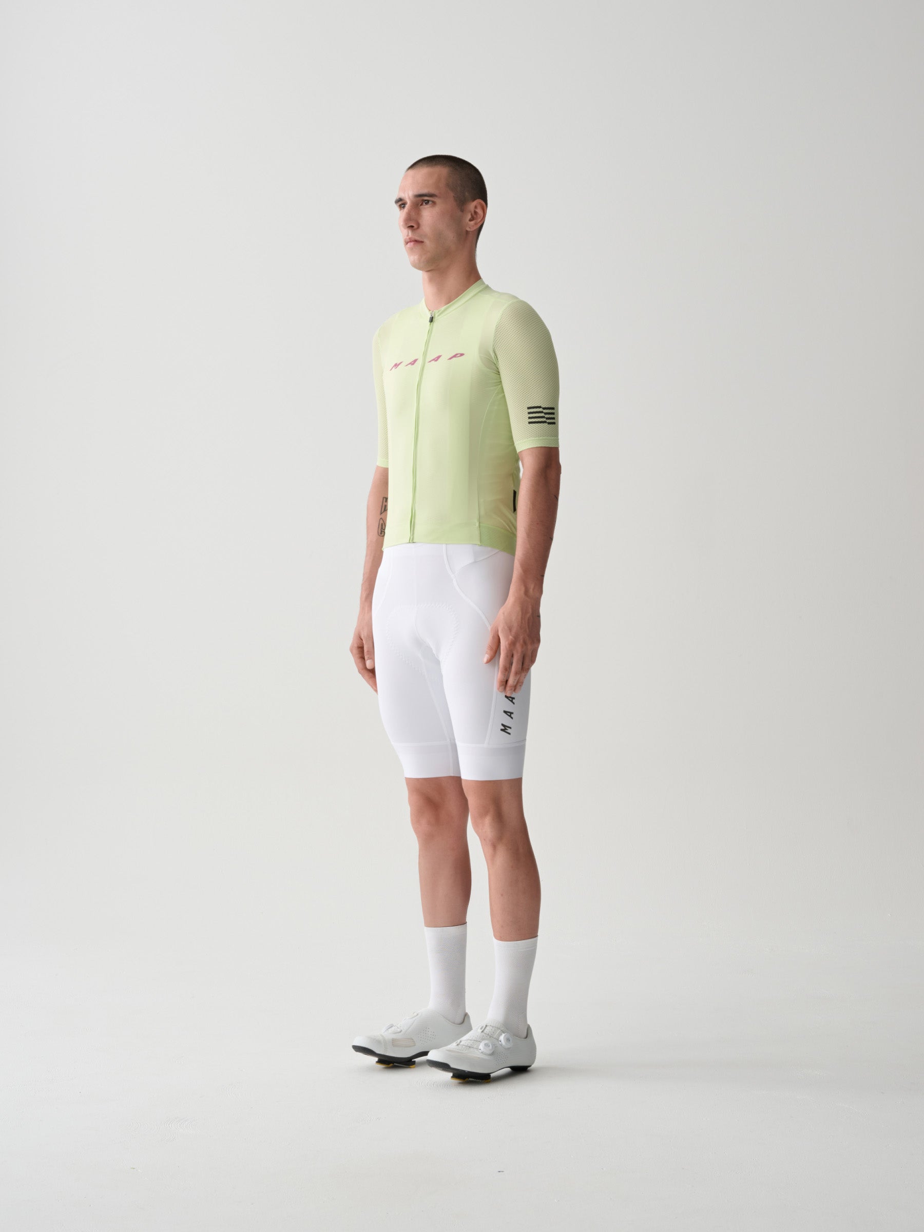 The front of a male model wearing White colored MAAP Team Bib Evo Cargo cycling bib shorts