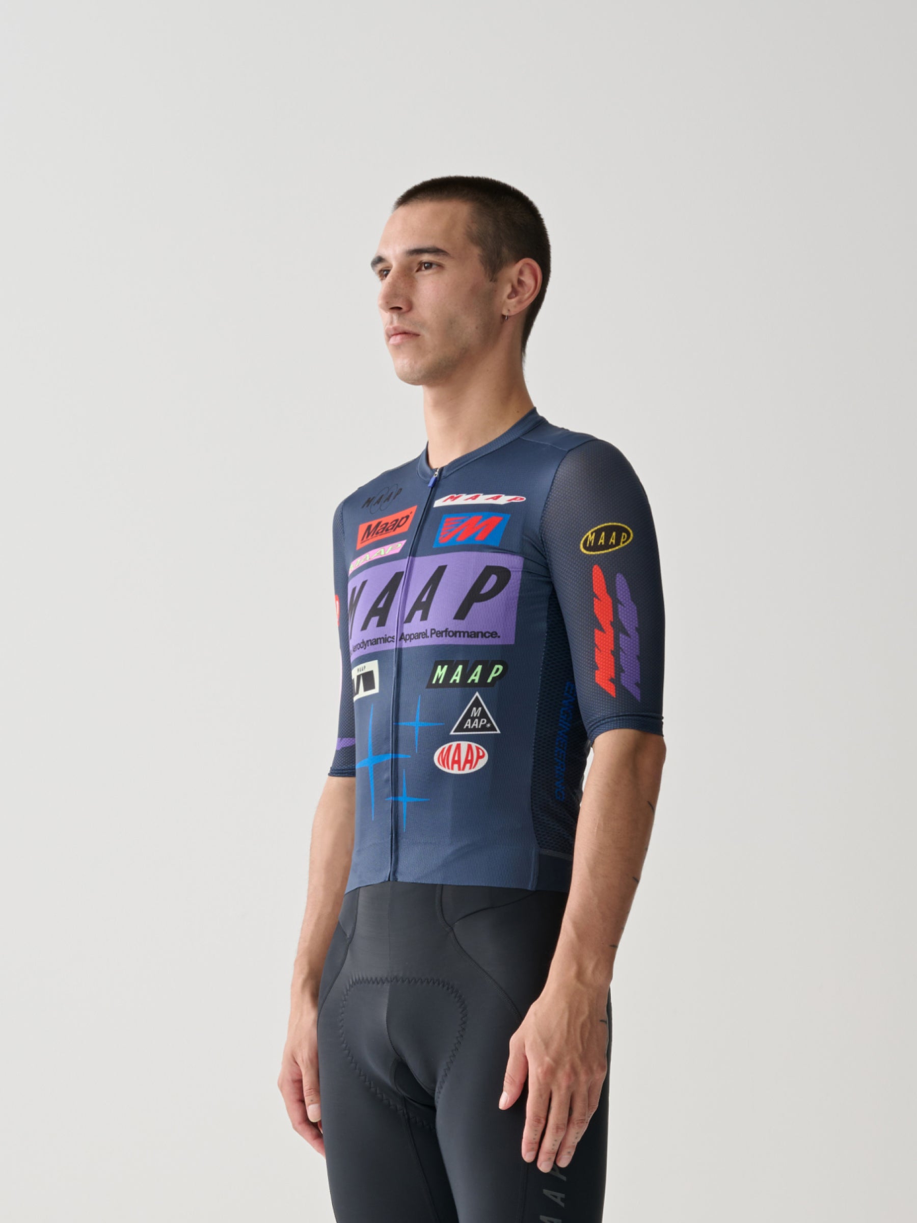 A male cyclist wearing a Men's MAAP Drome Short Sleeve Jersey in Midnight.