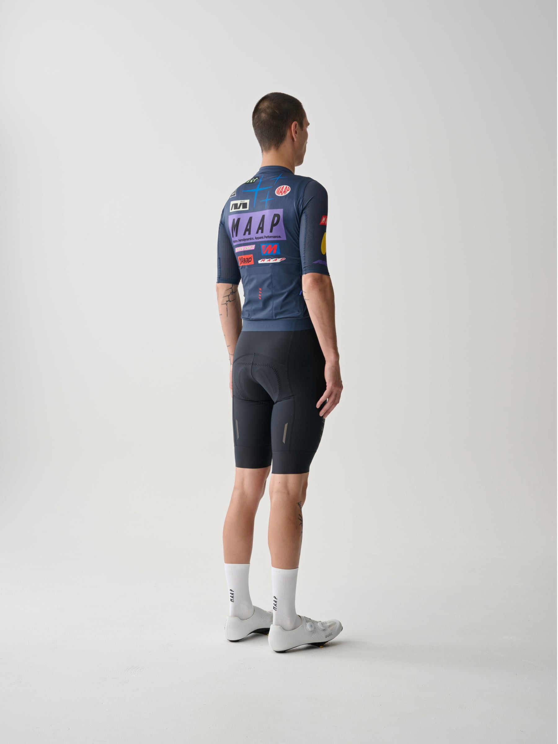 A male cyclist showing the back of a Men's MAAP Drome Short Sleeve Jersey in Midnight.