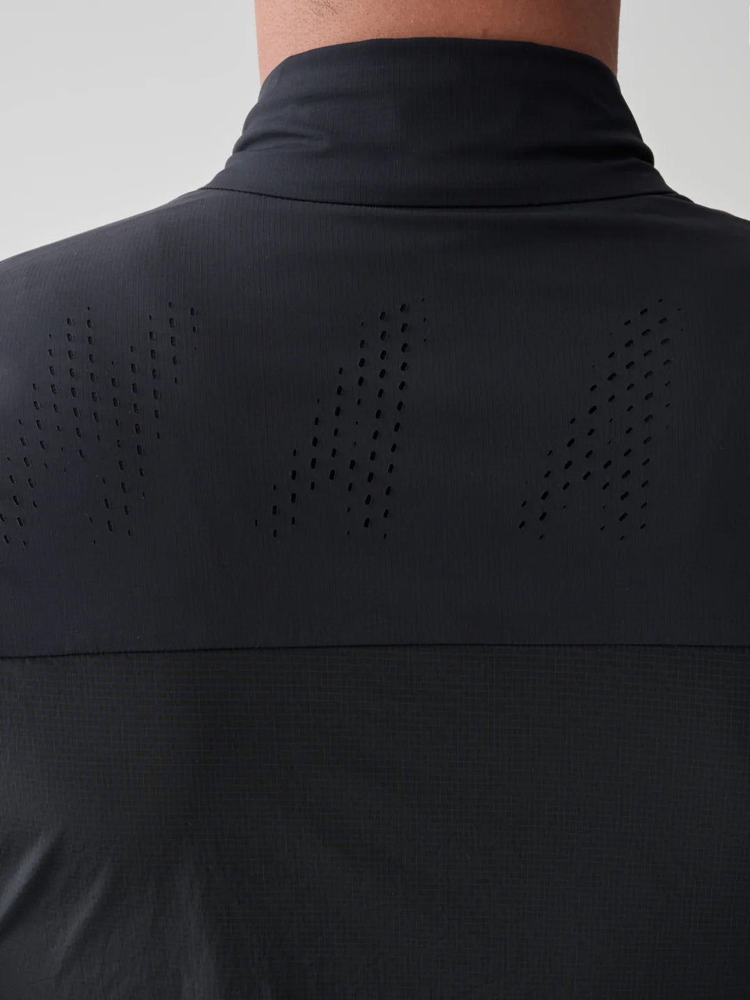 A detail of the perforated back panel on the MAAP Flow Vest in Black