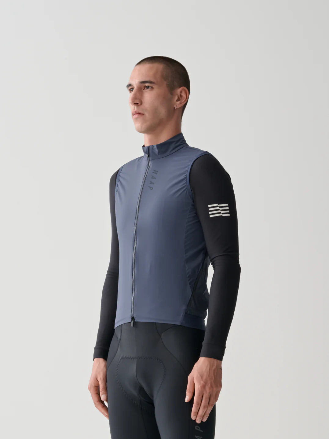 The upper half of a male cyclist wearing the MAAP Flow Vest in MIdnight Blue