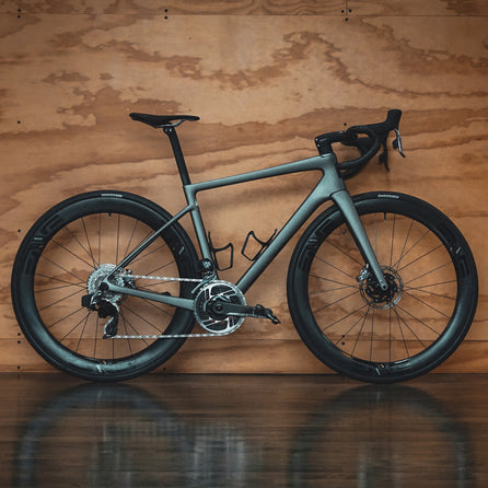 An Enve Melee leaning against a plywood wall