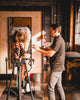 A Woman on a TT bike pedaling on a Wahoo Kickr Rollr during a Retul bike fitting session with a master bike fitter at Metier Racing & Coffee in Seattle