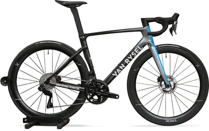 A Van Rysel RCR Pro Team Decathlon AG2R Replica Carbon Fiber Disc Brake Aero Road Racing Bicycle with a Black to Grey fade and blue accents on the fork with Shimano Dura Ace Di2 Groupset and Swiss Side wheels