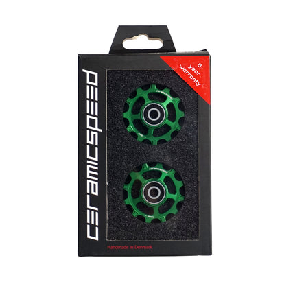 A pair of green CeramicSpeed Pulley Wheels for Shimano 11spd Drivetrains in a box