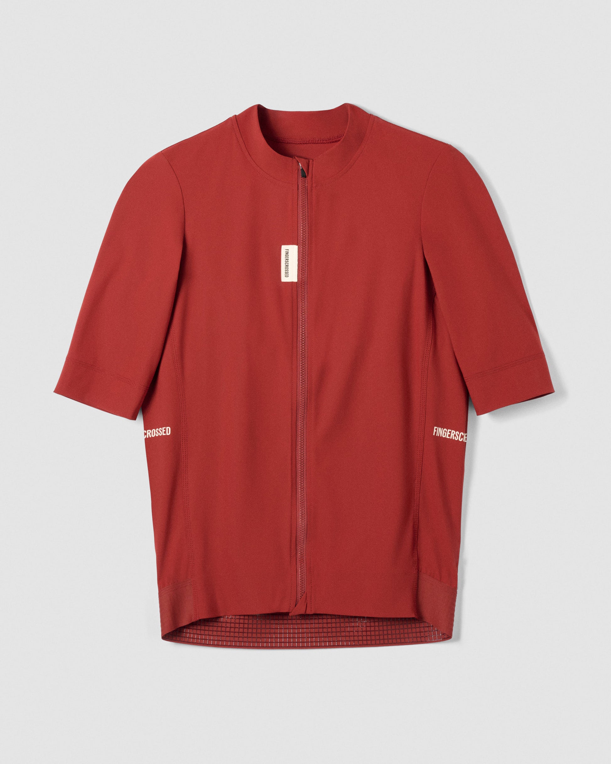 A Flat-lay image of the front of a Fingerscrossed #Road cycling jersey in Brick Red