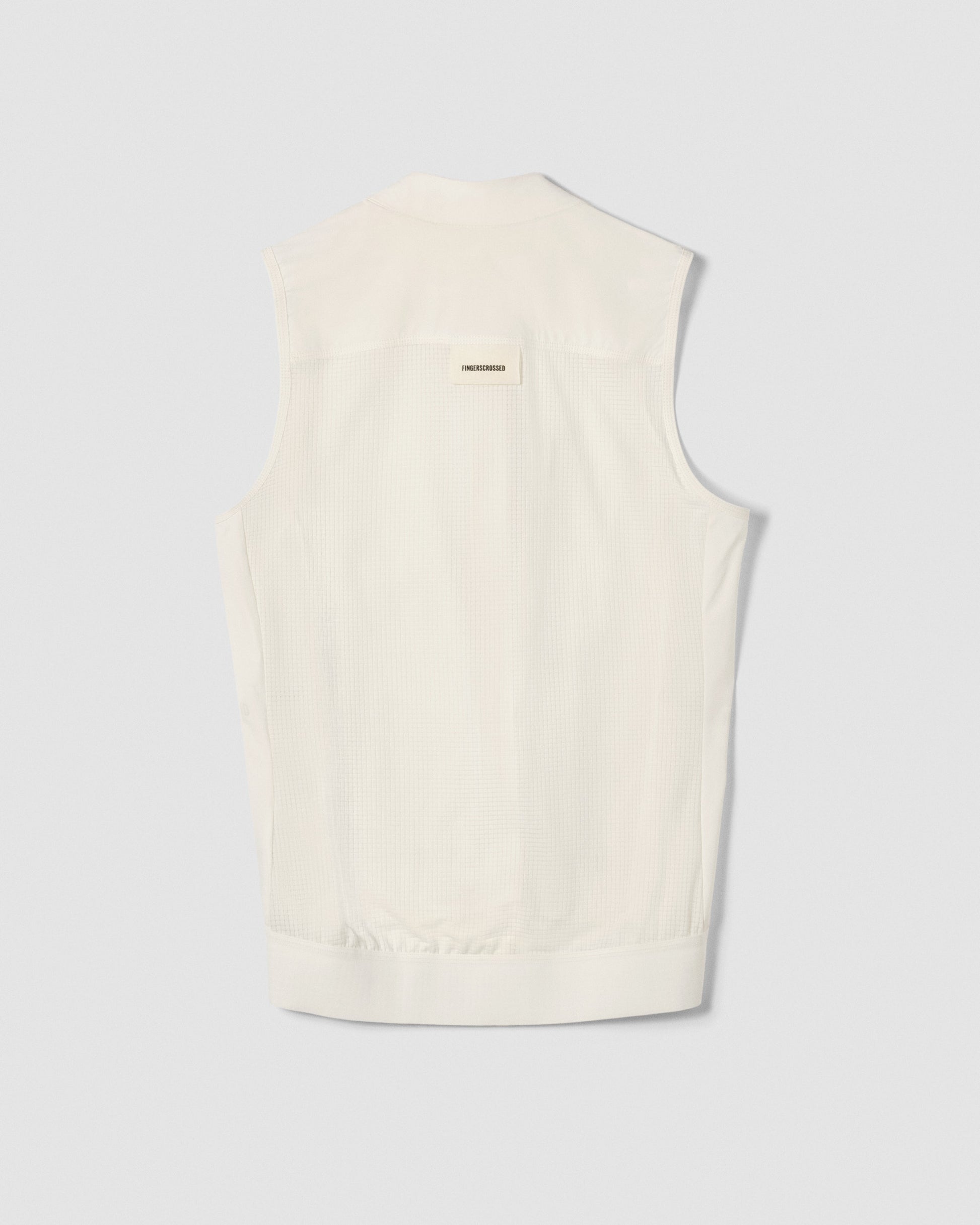 A flat lay image showing the back of a Fingerscrossed #ROAD vest in cream