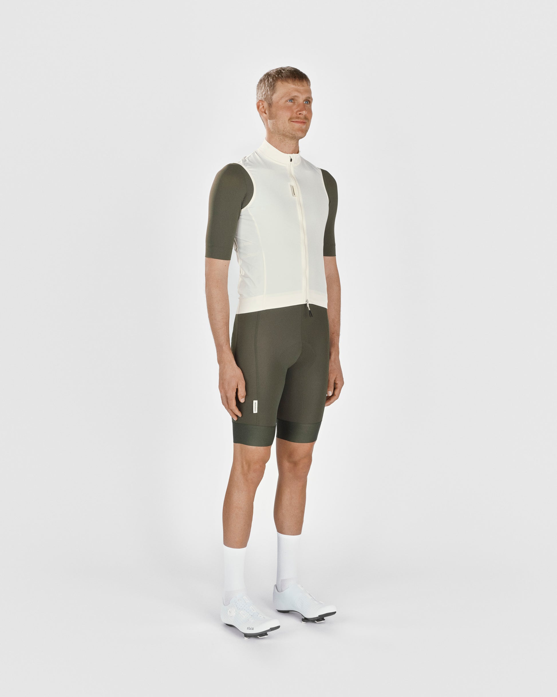 A male cyclist showing the front of a Fingerscrossed #Road cycling Vest in Cream