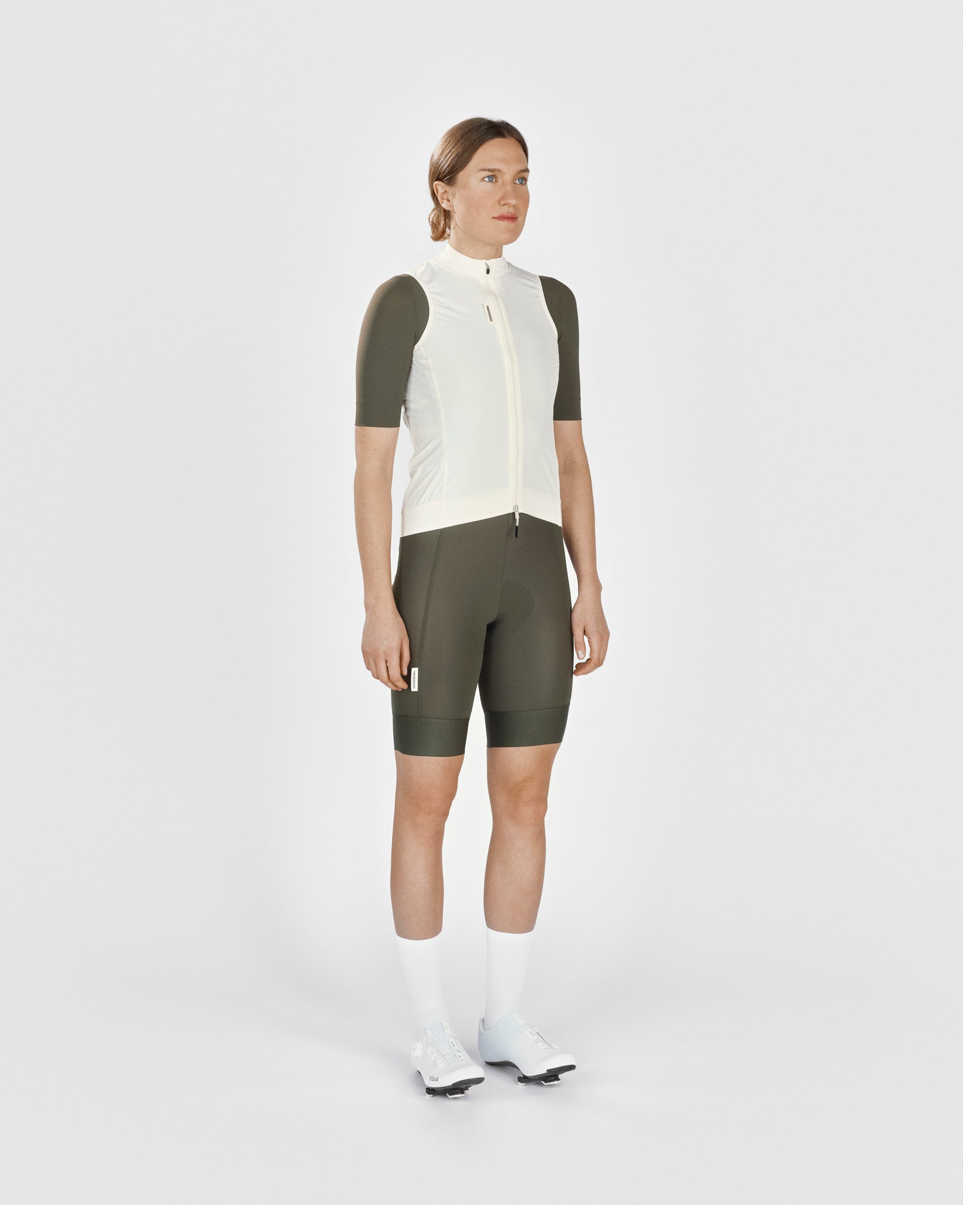A female cyclist showing the front of a Fingerscrossed #Road cycling Vest in Cream