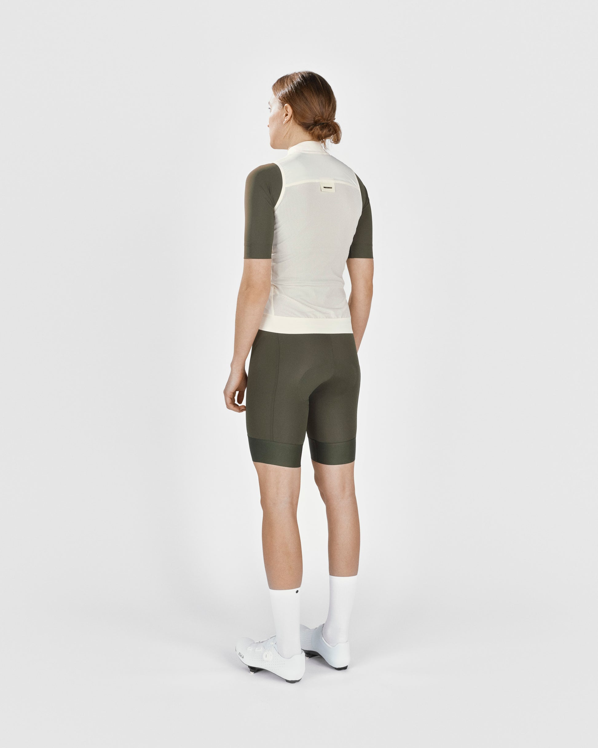A female cyclist showing the back of a Fingerscrossed #Road cycling Vest in Cream