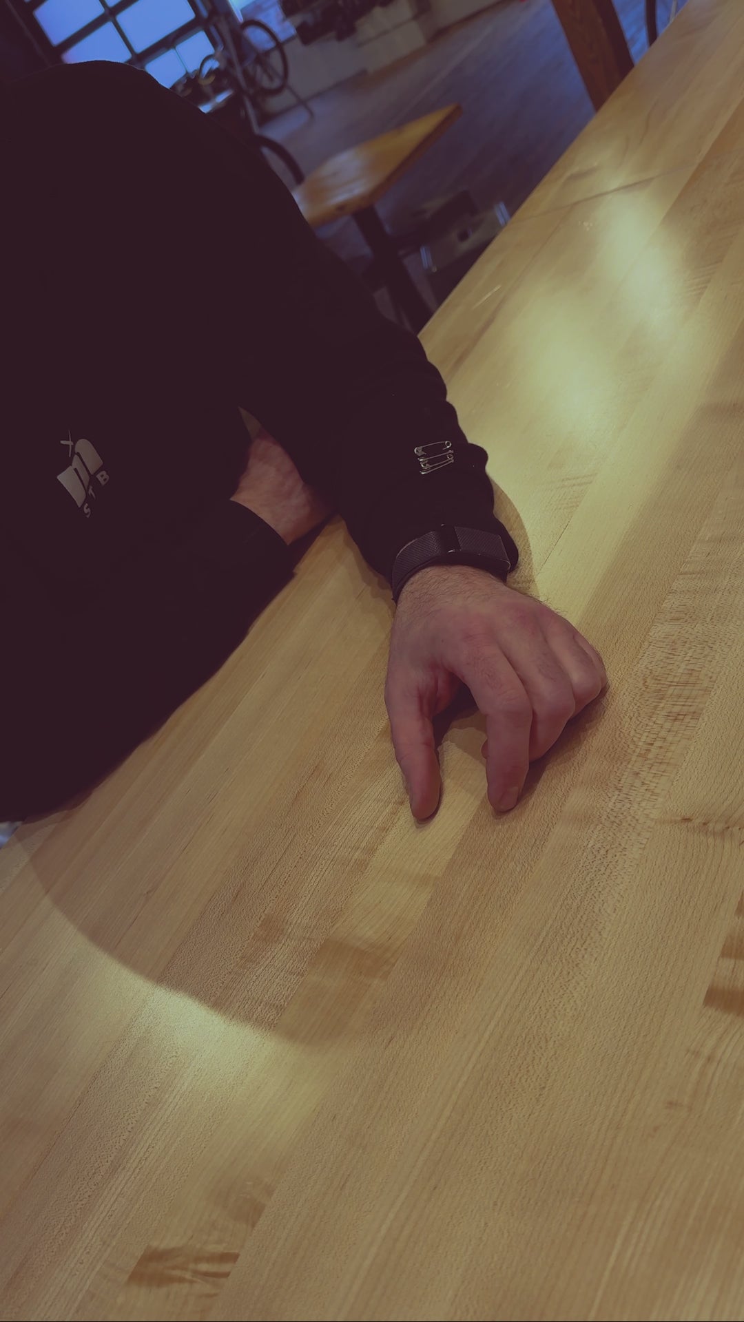 A Beer sliding across the bar into the hands of a customer after a bike ride at Metier Cycling and Cafe