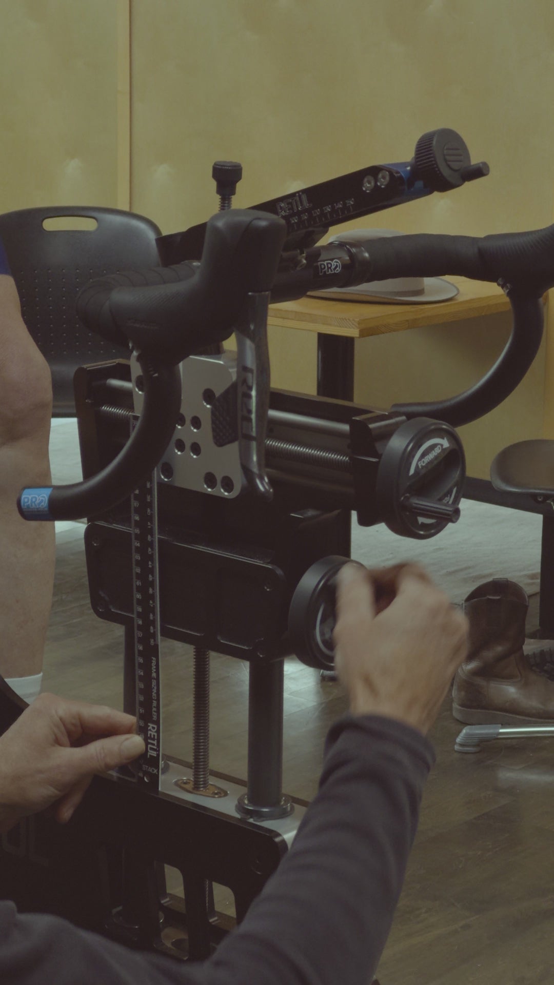 A master bike fitter at Métier Seattle adjusts the stack height of his Retul bike during a New Bike Sizing bicycle fit