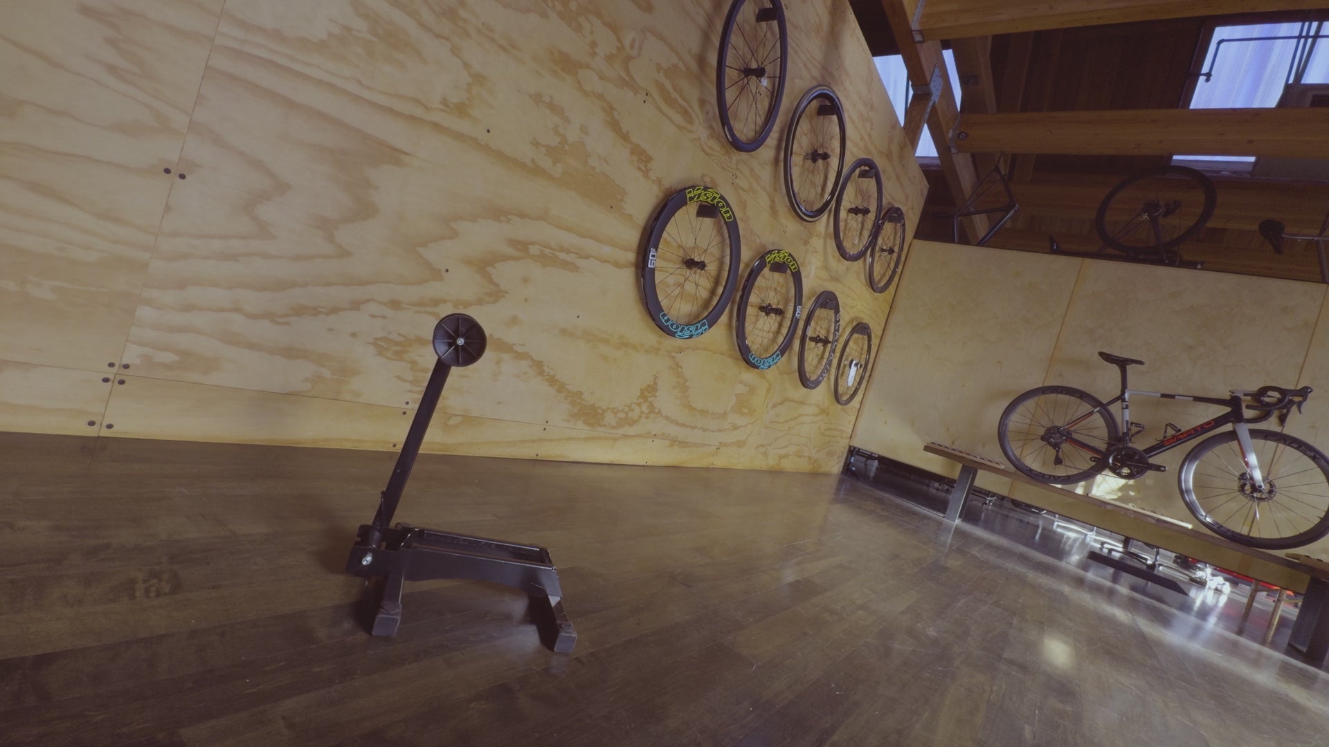 An employee at Metier Cycling and Cafe places a custom built Cervelo Soloist carbon race bicycle into a bike rack in Metier's custom bicycle room 