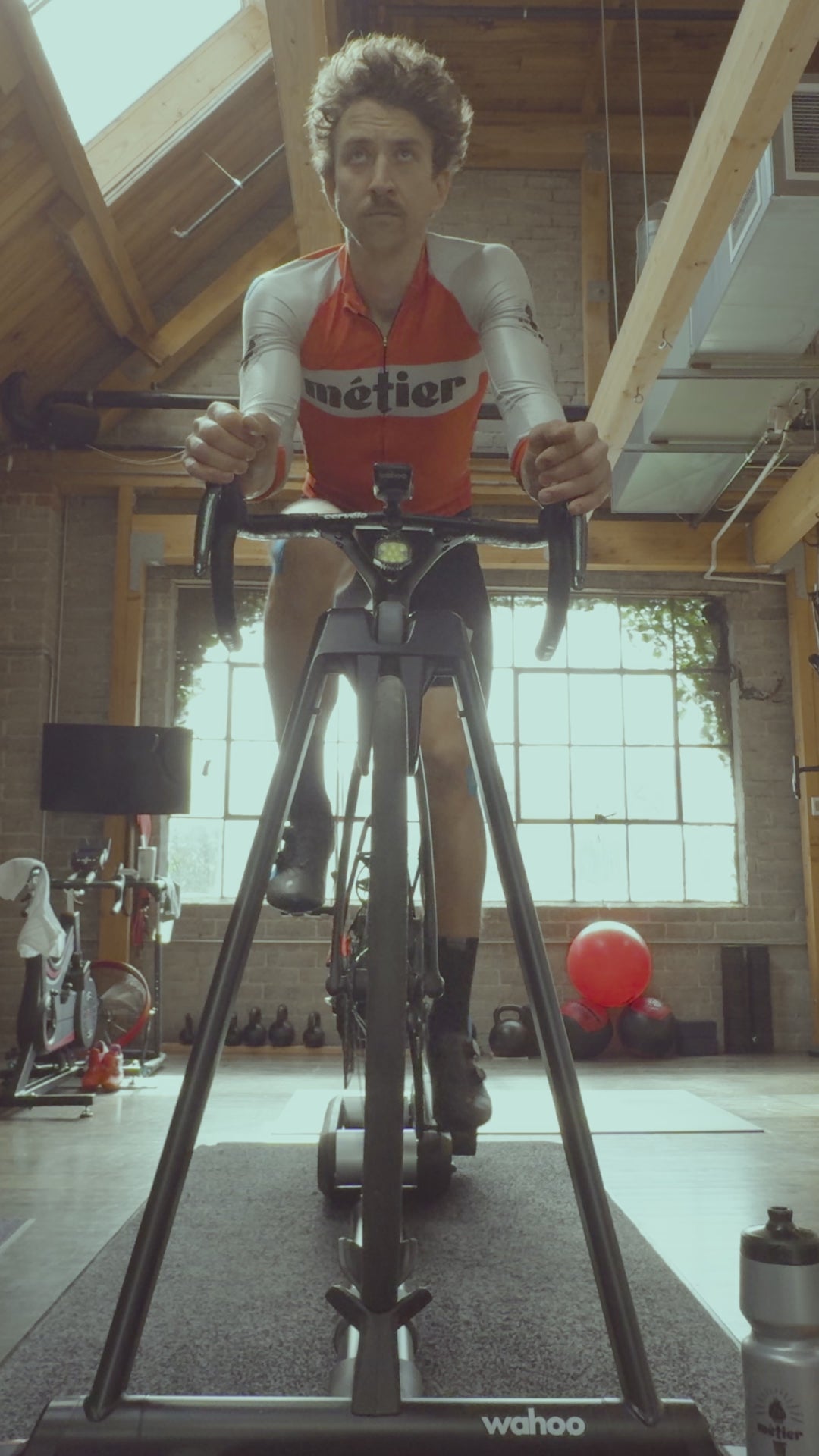 A road cyclist in Métier Seattle cycling kit rides his Cervelo S5 during a professional Premium Bike Fit at Métier Cycling & Cafe in Seattle