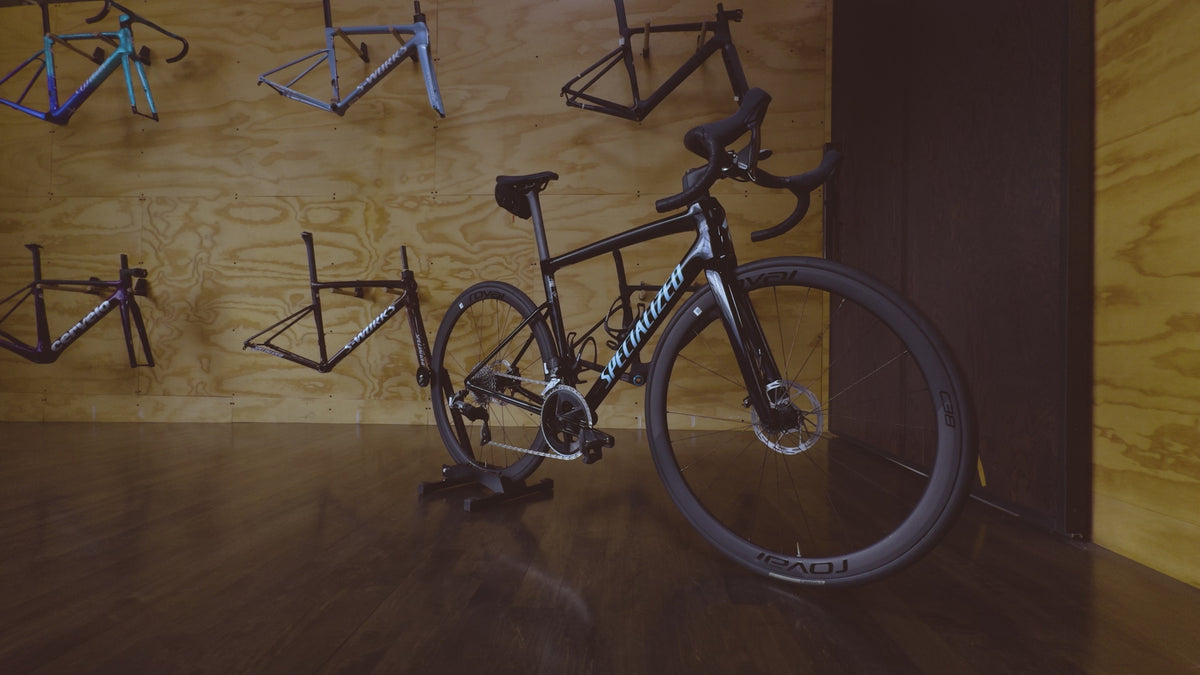 A Specialized Tarmac SL8 Carbon Road Rental Bike displayed in the custom bike room at Metier Seattle
