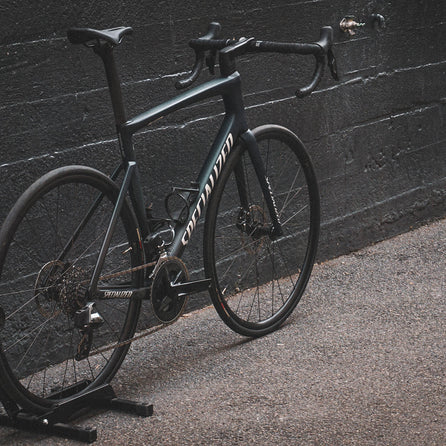 A Specialized Tarmac SL7 against a black wall
